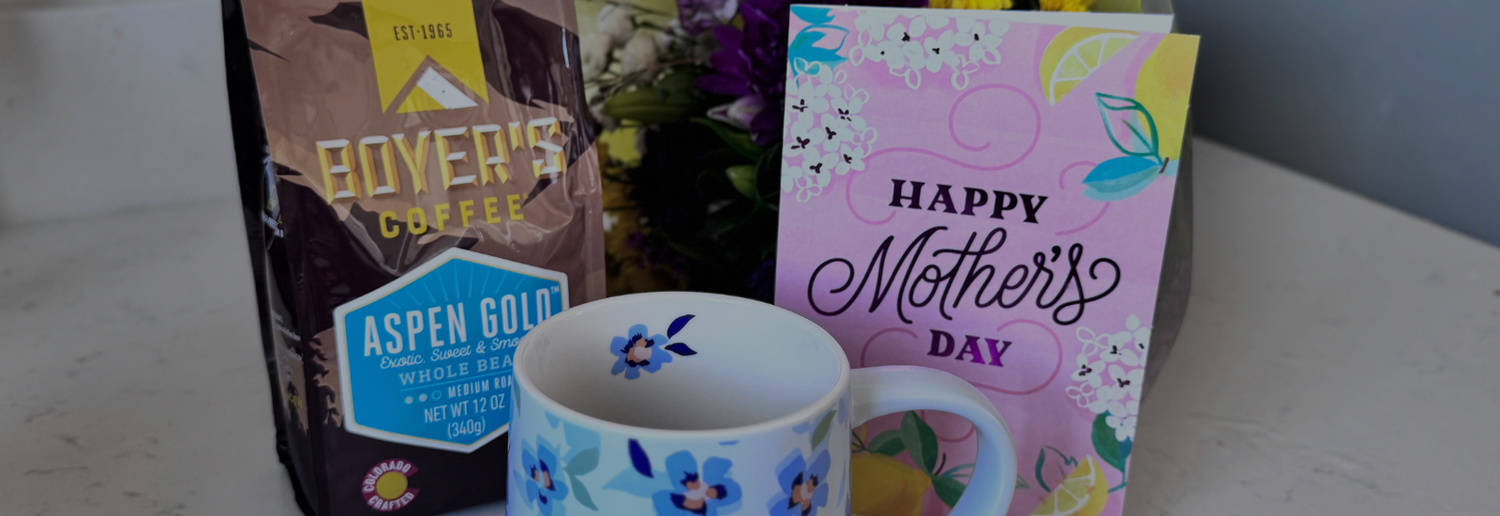 Bag of Boyer's Coffee Aspen Gold with a mother's day card, mug and floral bouquet on a white countertop