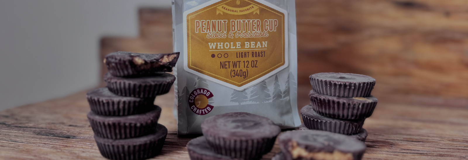 Peanut butter cups and a bag of whole bean coffee on a wooden surface