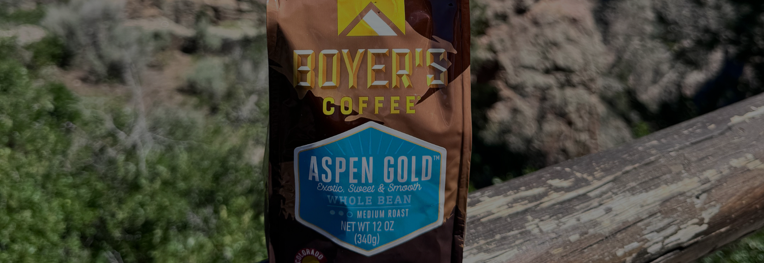 Boyer's Coffee Aspen Gold package on a wooden surface with a natural background