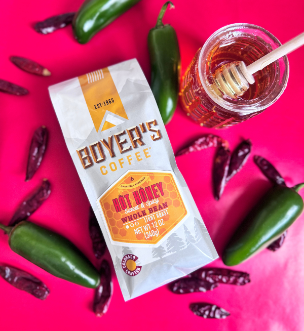 Boyer's Coffee Hot Honey package with honey and peppers on a pink background