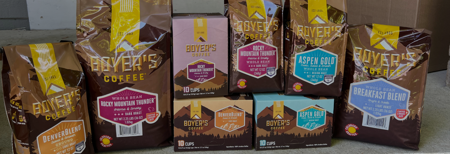 Various packages of Boyer's Coffee on a gray surface