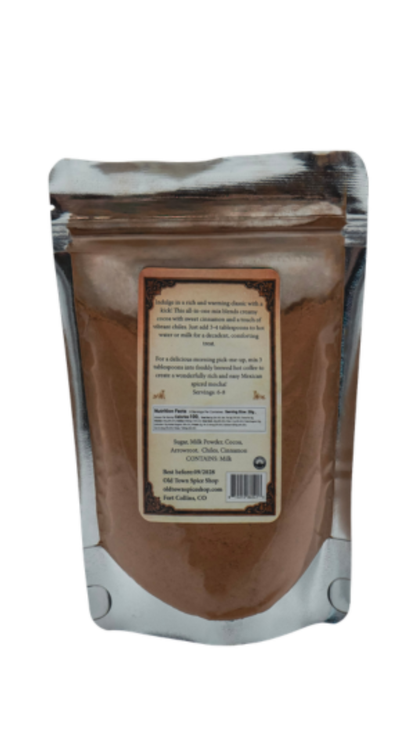 Back of Bag of Mexican Hot Cocoa showing a clear pouch with cocoa inside and instructions on how to prepare.